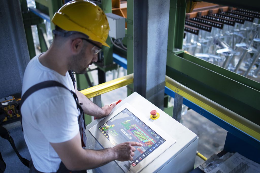 factory-worker-monitoring-industrial-machines-production-remotely-control-room-min